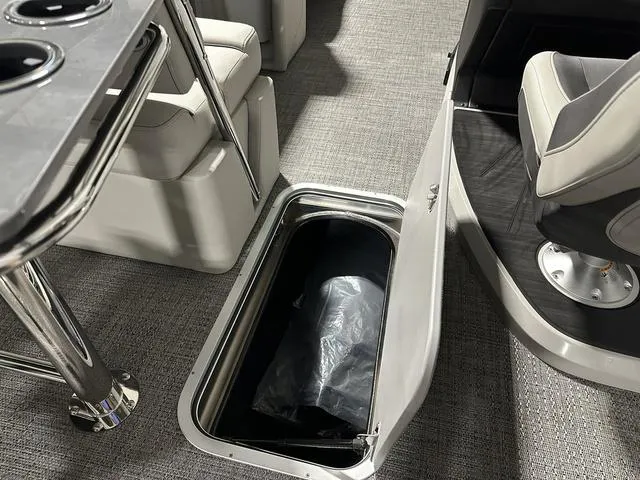 Slide: The Image of 2025 Barletta Boats Cabrio C24UE interior storage compartment and seating area. - 24