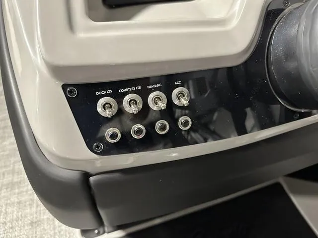 Slide: The Image of Control panel of 2025 Barletta Boats Cabrio C24UE with labeled switches. - 26