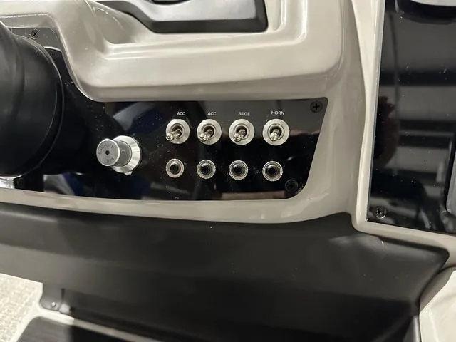 Slide: The Image of Control panel of 2025 Barletta Boats Cabrio C24UE with switches and knobs. - 27