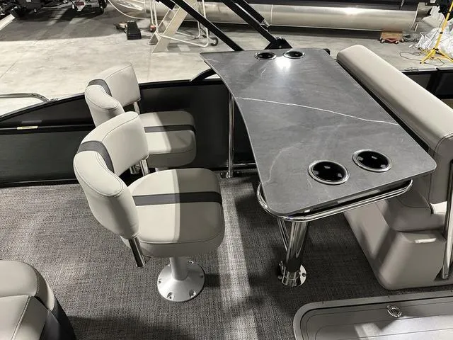 Slide: The Image of 2025 Barletta Boats Cabrio C24UE interior with modern seating and table. - 30