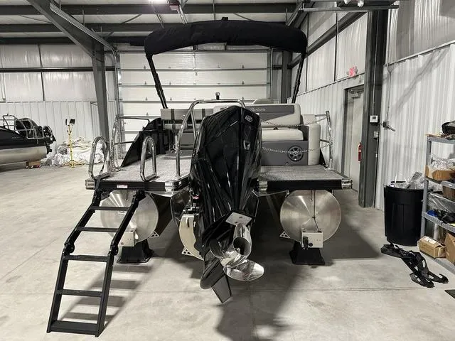 Slide: The Image of 2025 Barletta Boats Cabrio C24UE pontoon boat in a storage facility. - 5