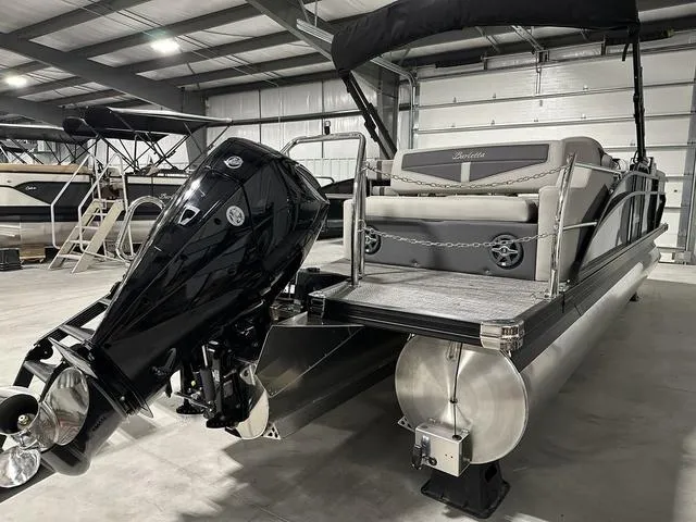 Slide: The Image of 2025 Barletta Boats Cabrio C24UE pontoon boat in a showroom. - 6