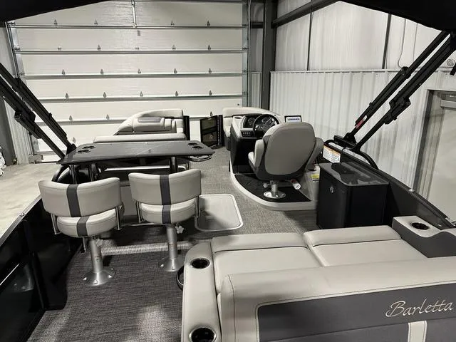 Slide: The Image of 2025 Barletta Boats Cabrio C24UE interior with modern seating and helm station. - 8
