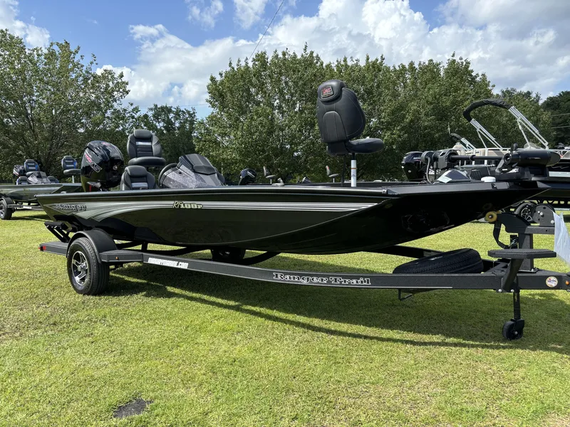 Slide: The Image of 2024 Ranger RT188P fishing boat on trailer, parked on grass under a cloudy sky. - 15