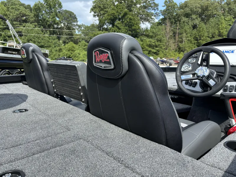 Slide: The Image of 2024 Ranger RT188P boat interior with steering wheel and seats, surrounded by lush greenery. - 7