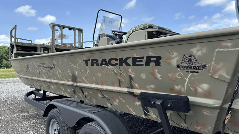 Slide: The Image of 2024 Tracker Grizzly 2072 CC SportMan boat with camouflage design on a trailer. - 3