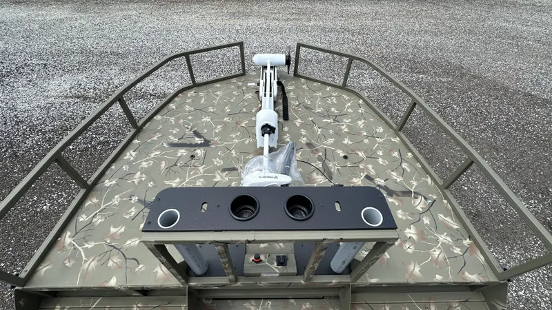 Slide: The Image of 2024 Tracker Grizzly 2072 CC SportMan boat with camo deck and fishing rod holders. - 5