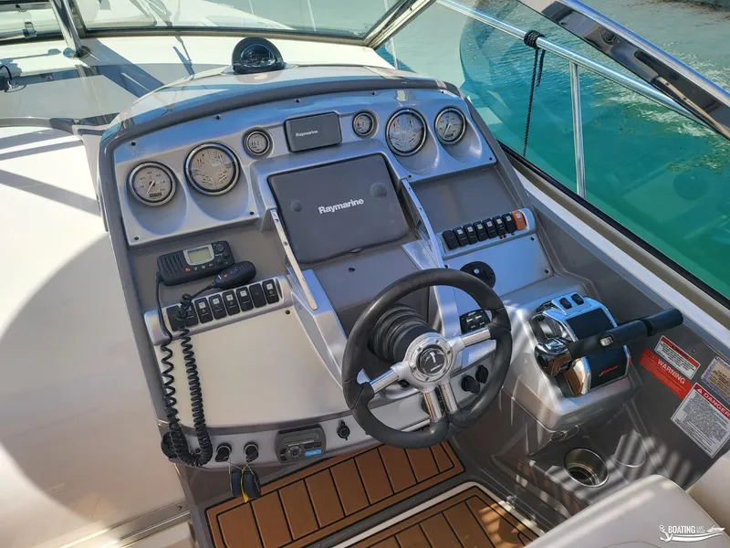 Slide: The Image of 2008 Monterey 350 Sport Yacht helm with Raymarine electronics and teak flooring. - 17