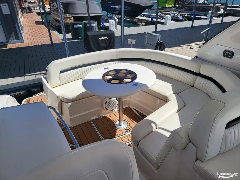Slide: The Image of 2008 Monterey 350 Sport Yacht interior with white seating and table at marina. - 18
