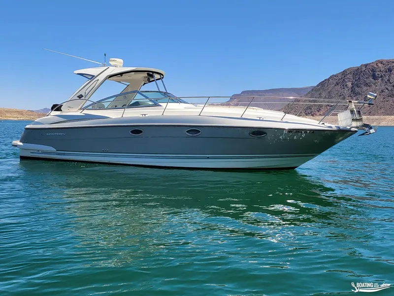 Slide: The Image of 2008 Monterey 350 Sport Yacht on clear blue water with scenic mountain backdrop. - 2