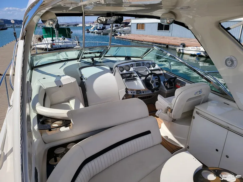 Slide: The Image of 2008 Monterey 350Sport Yacht interior, featuring helm, seating, and docked at marina. - 20