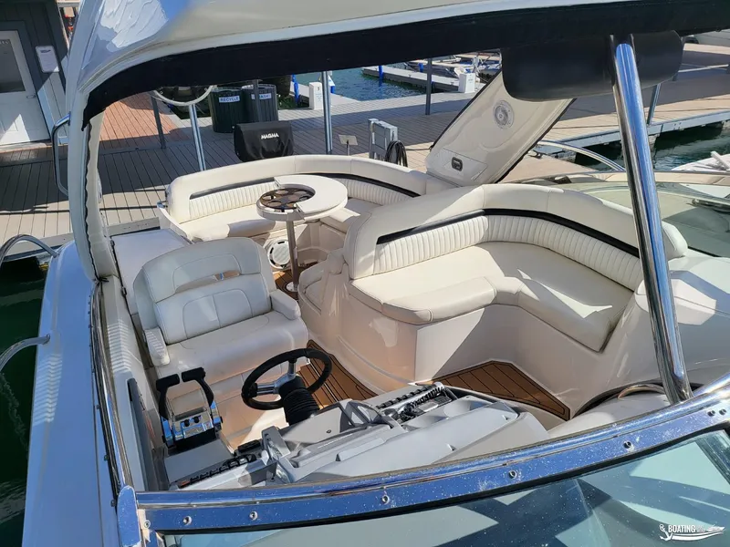 Slide: The Image of 2008 Monterey 350Sport Yacht interior with white seating and helm at dock. - 21