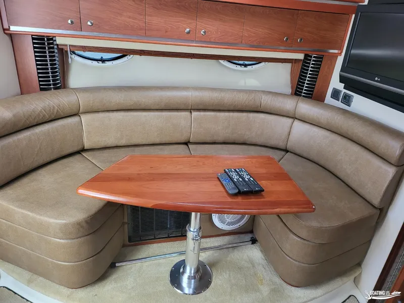 Slide: The Image of Interior of 2008 Monterey 350 Sport Yacht with curved seating and wooden table. - 24