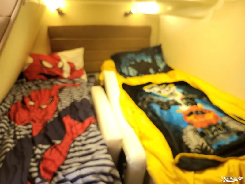 Slide: The Image of 2008 Monterey 350Sport Yacht cabin with twin beds and superhero-themed bedding. - 27