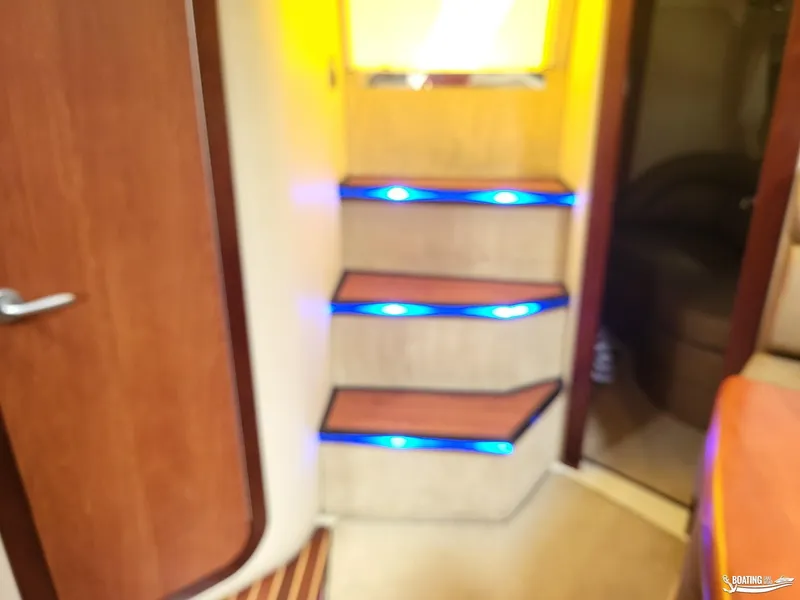 Slide: The Image of Interior stairs with blue LED lights on a 2008 Monterey 350 Sport Yacht. - 28