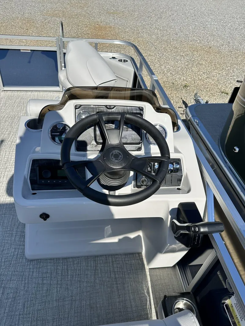 Slide: The Image of 2024 Avalon VTX Quad Fish 19 FT boat steering console with modern controls. - 6