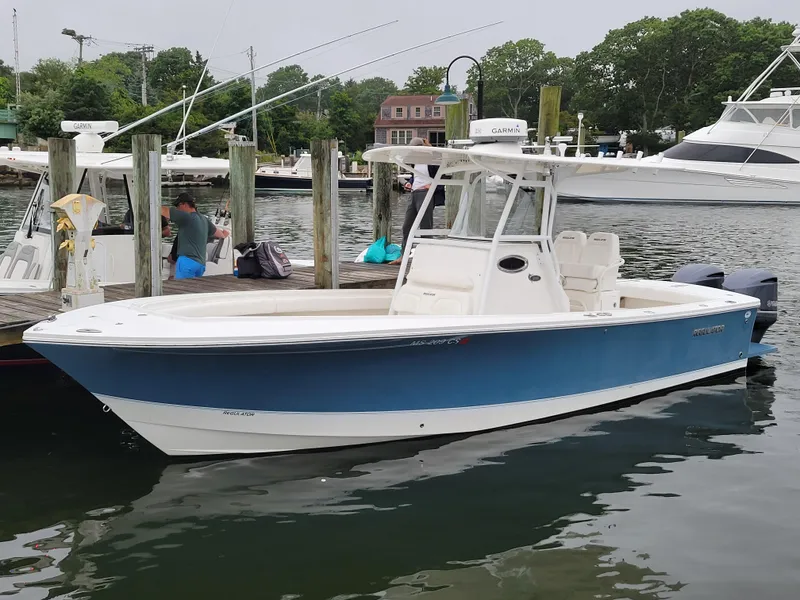 Slide: The Image of 2014 Regulator 28 Forward Seating boat docked at a marina. - 13