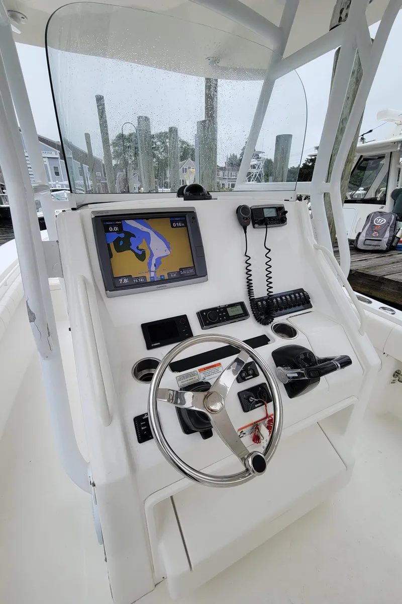 Slide: The Image of 2014 Regulator 28 Forward Seating boat helm with navigation system and controls. - 4