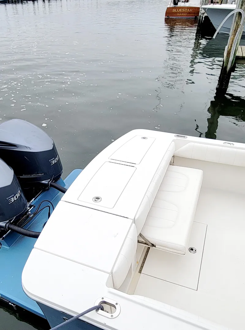 Slide: The Image of 2014 Regulator 28 Forward Seating boat docked with twin engines. - 6