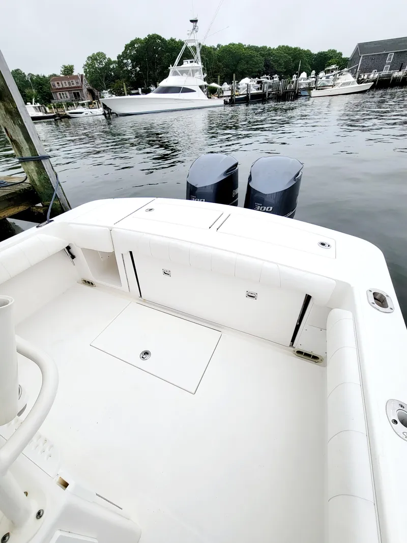 Slide: The Image of 2014 Regulator 28 Forward Seating boat docked at a marina. - 8