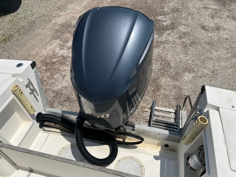 Slide: The Image of 1985 Mako 258 Cuddy boat with a modern outboard motor. - 19