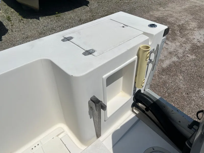 Slide: The Image of 1985 Mako 258 Cuddy boat interior, showing storage compartments and deck details. - 21