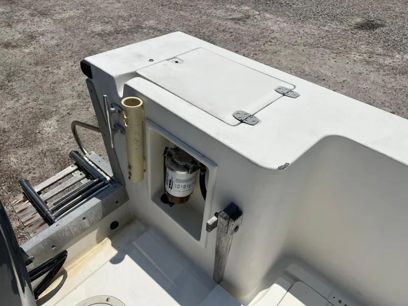 Slide: The Image of 1985 Mako 258 Cuddy boat stern with storage compartment and fuel filter. - 23