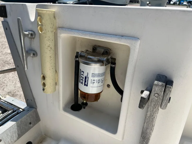 Slide: The Image of 1985 Mako 258 Cuddy fuel filter compartment with mounted filter. - 24