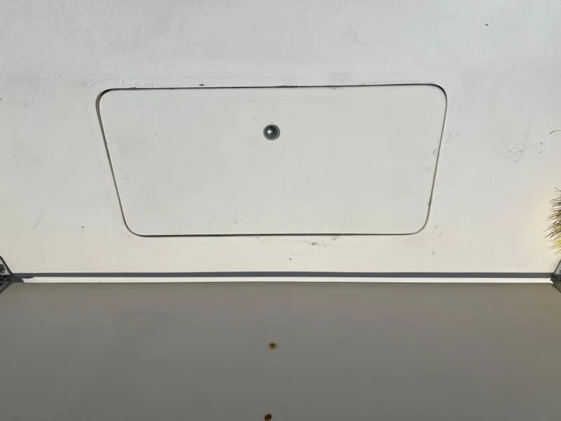 Slide: The Image of 1985 Mako 258 Cuddy boat hatch cover with a central latch. - 27