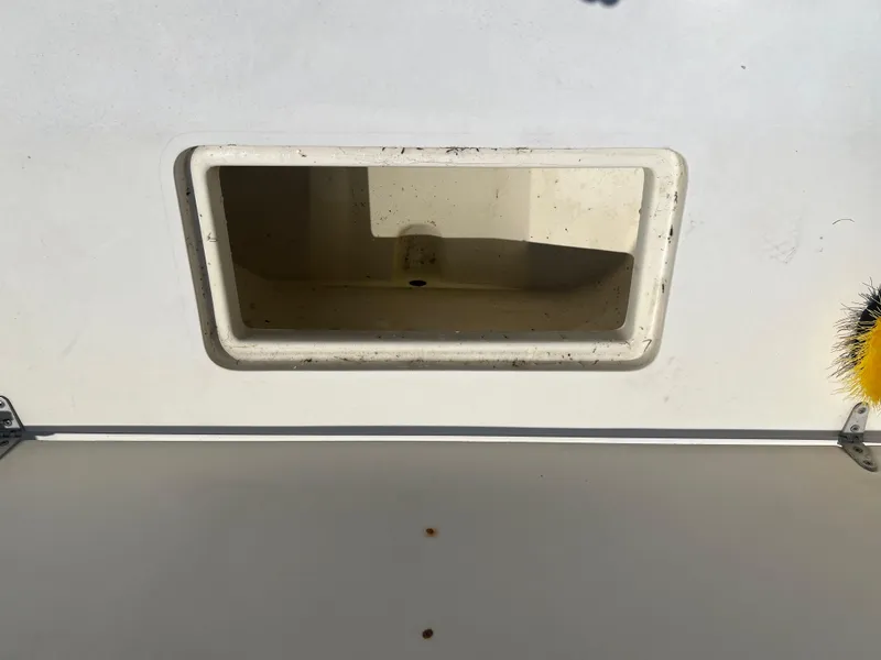Slide: The Image of 1985 Mako 258 Cuddy boat storage compartment, open and empty. - 28