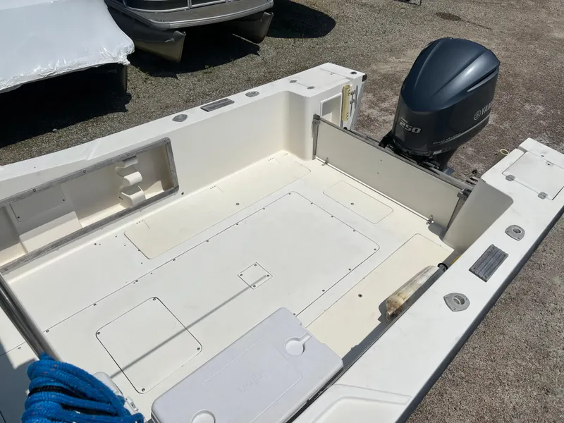 Slide: The Image of 1985 Mako 258 Cuddy boat deck with outboard motor. - 32