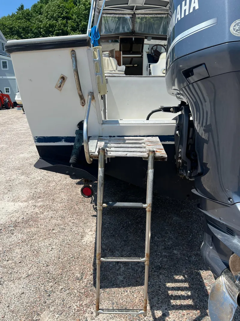 Slide: The Image of 1985 Mako 258 Cuddy with Yamaha outboard motor and boarding ladder. - 37