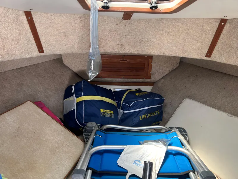 Slide: The Image of Interior of 1985 Mako 258 Cuddy cabin with life jackets and folded chair. - 40