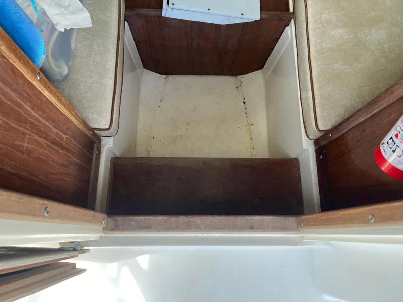 Slide: The Image of Interior of 1985 Mako 258 Cuddy boat showing storage compartments and seating. - 41