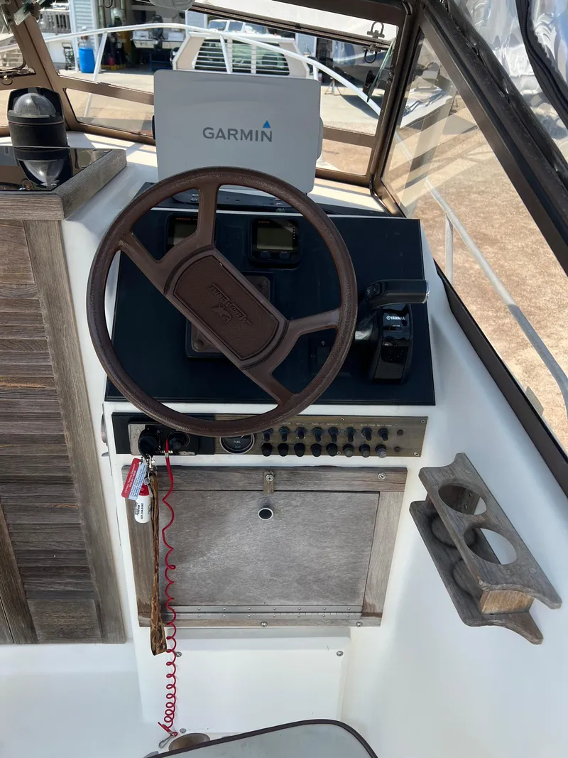 Slide: The Image of 1985 Mako 258 Cuddy boat helm with Garmin navigation system. - 45