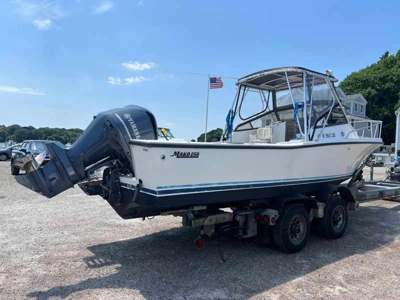 Slide: The Image of 1985 Mako 258 Cuddy boat on a trailer with outboard motor. - 6