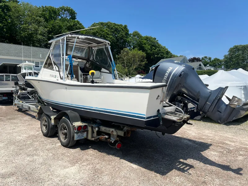 Slide: The Image of 1985 Mako 258 Cuddy boat on a trailer with Yamaha outboard motor. - 8