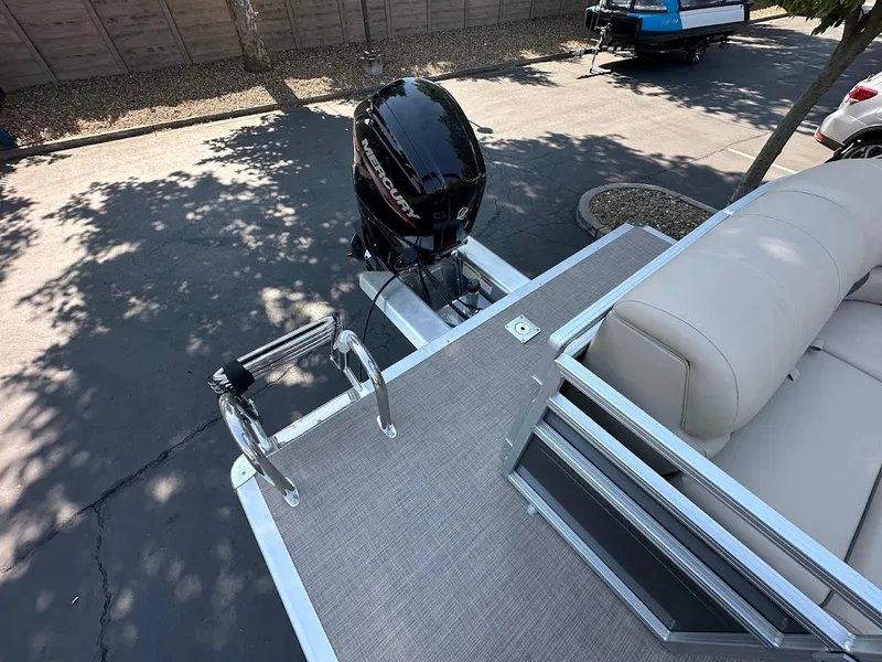 Slide: The Image of 2024 Sun Tracker Party Barge 20 DLX with outboard motor and seating area. - 14