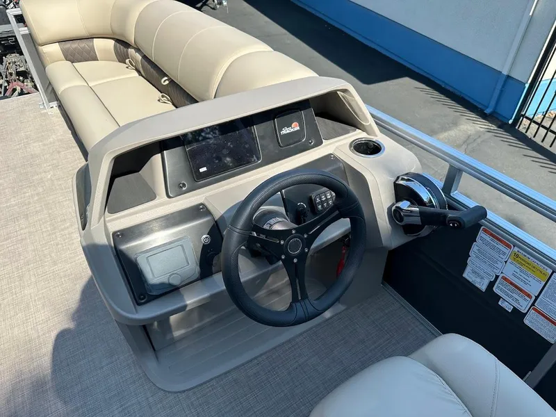 Slide: The Image of 2024 Sun Tracker Party Barge 20 DLX interior with steering console and seating. - 18