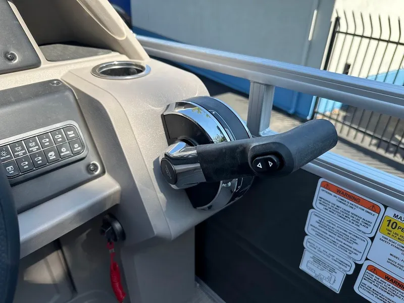 Slide: The Image of 2024 Sun Tracker Party Barge 20 DLX throttle control and dashboard details. - 21