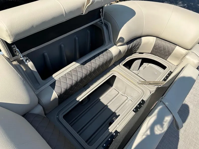 Slide: The Image of 2024 Sun Tracker Party Barge 20 DLX seating with open storage compartments. - 23