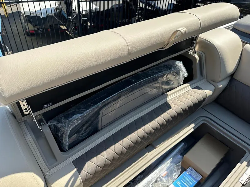 Slide: The Image of 2024 Sun Tracker Party Barge 20 DLX storage compartment with cushioned seating. - 27