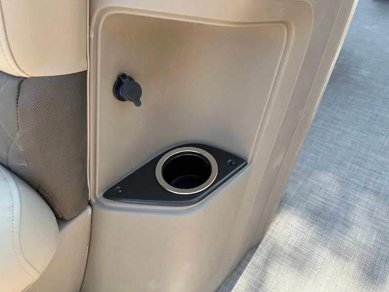 Slide: The Image of 2024 Sun Tracker Party Barge 20 DLX cup holder and power outlet detail. - 28