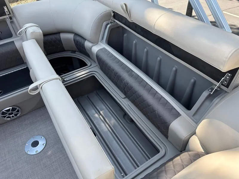 Slide: The Image of 2024 Sun Tracker Party Barge 20 DLX seating with open storage compartments. - 32