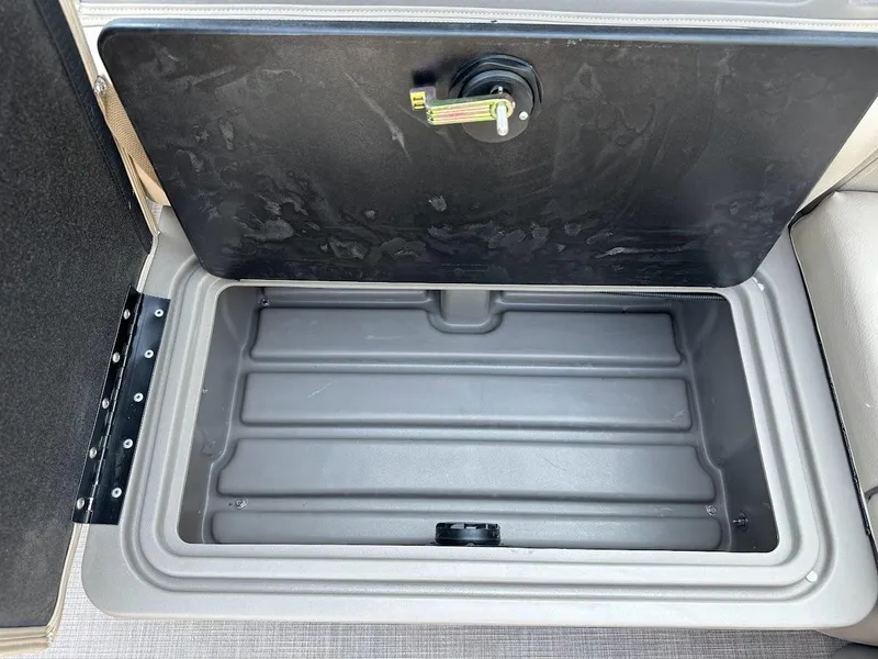 Slide: The Image of 2024 Sun Tracker Party Barge 20 DLX storage compartment, open and empty. - 35