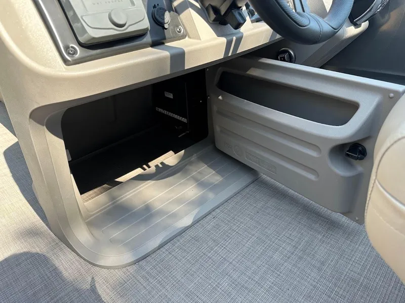 Slide: The Image of 2024 Sun Tracker Party Barge 20 DLX interior dashboard and storage compartment. - 36