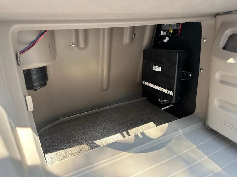 Slide: The Image of 2024 Sun Tracker Party Barge 20 DLX storage compartment with electrical components. - 37