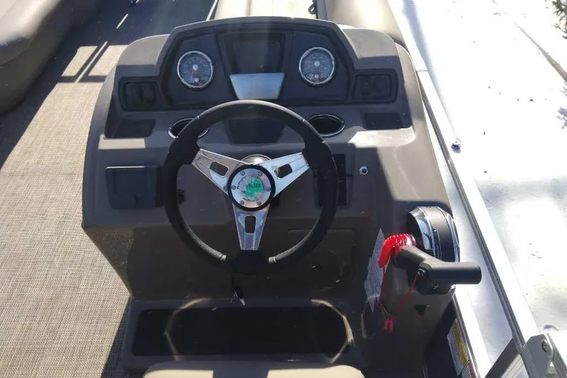 Slide: The Image of 2024 Ranger Reata 200C boat dashboard with steering wheel and controls. - 3