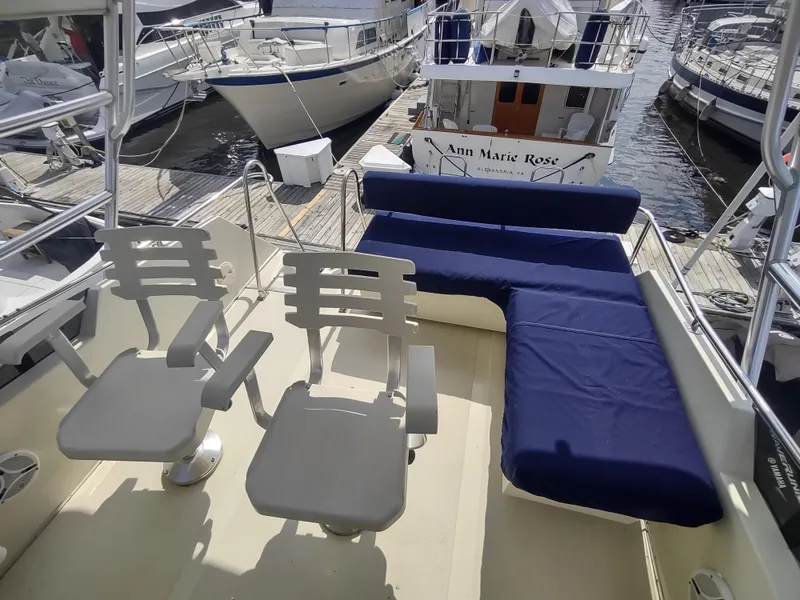 Slide: The Image of Upper deck of 1988 Tollycraft 34 Sport Sedan with seating and blue cushions. - 34