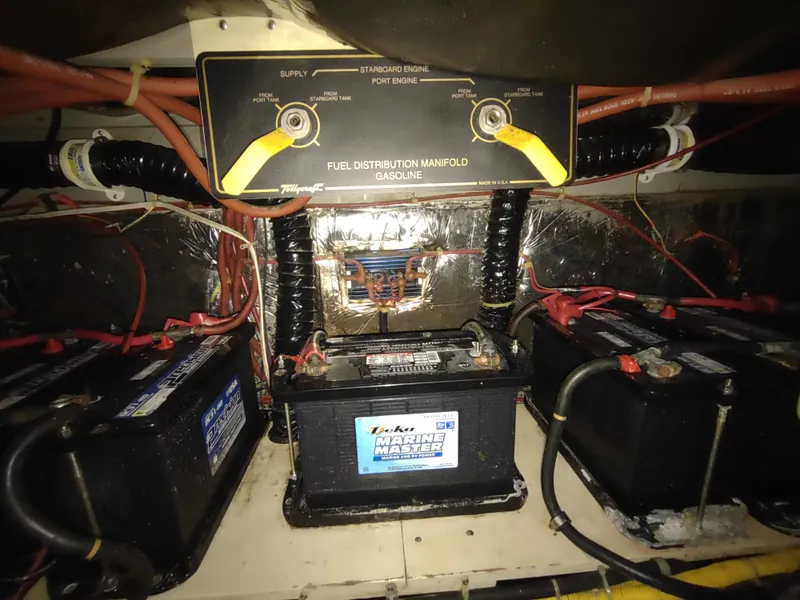 Slide: The Image of 1988 Tollycraft 34 Sport Sedan engine room with batteries and fuel distribution manifold. - 41